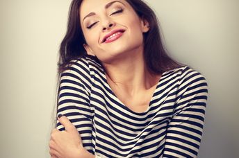 Woman hugging herself