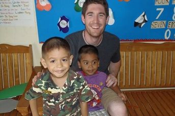 Christian Clark with children at daycare in Thailand (courtesy of Projects Abroad)