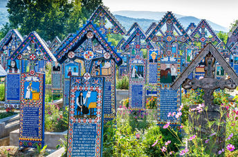 Painted wooden crosses in the famous Merry Cemetery in Maramures, Romania. (Danilovski / Shutterstock.com)