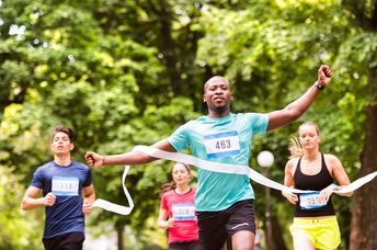 A runner crosses the finish line a ahead of his competitors