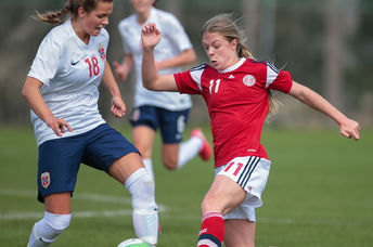 Andrea Norheim (#18 Norway) and Freja Kjaersig Sunesen (#11 Denmark) fight for the ball during a UEFA women's U17 qualifying game