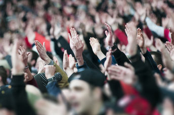 Fans of the University of Iowa football team wave at children at the University of Iowa wave at children at the Stead Family Children's Hospital across from the stadium