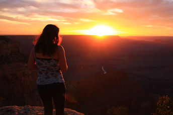 A woman looking in awe at a beautiful sunset