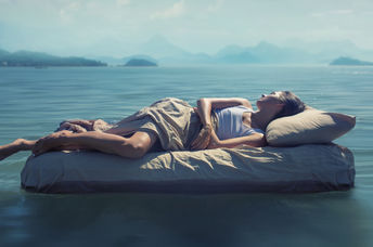 A woman sleeps in a dark room