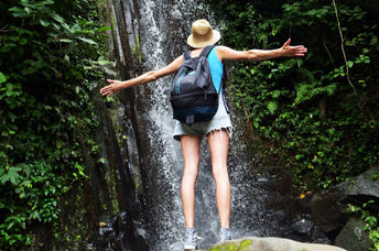 person walking in a green forest