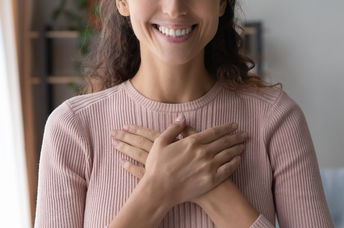A woman smiles after receiving a compliment.