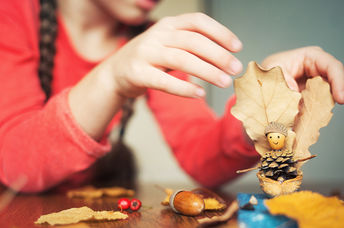 Child painting pinecones