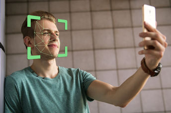 Man scanning face with smartphone