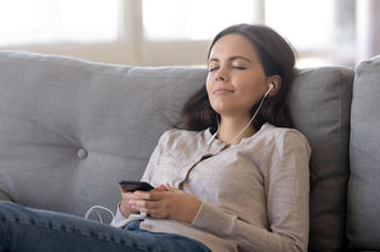 Woman listing to relaxing sleep music.