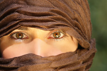 Veiled woman working outdoors