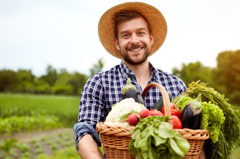 Young farmer holding crops