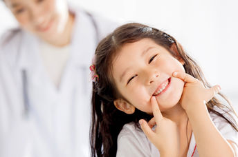 Happy girl with kind doctor