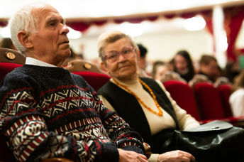 Senior couple enjoying performance at opera and ballet theater.