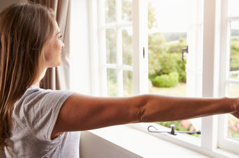 Woman thinking about her goals by a window