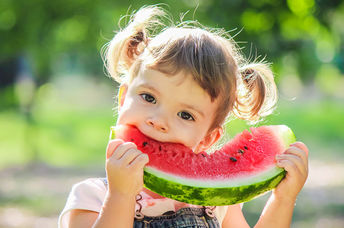 Girl eating watermelon.