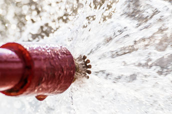 Sprinkler head shooting our fire-suppression materials.