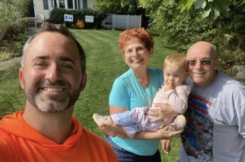 Brian Schwartz with happy senior citizens and their grandchild.
