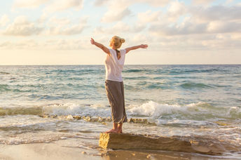 A calm and relaxed woman at the beach.