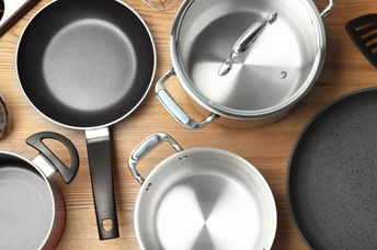 A selection of kitchen cookware including pots, pans, and utensils.