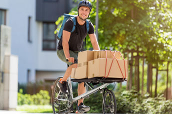 Bicycle messenger making a delivery on a cargo bike