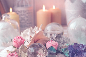 Flickering candles alongside crystals and healing stones are used to manifest dreams.