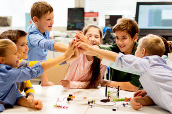 Happy children learning about tech at school
