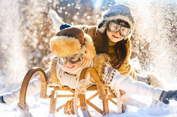 Two boys enjoying a winter wonderland.