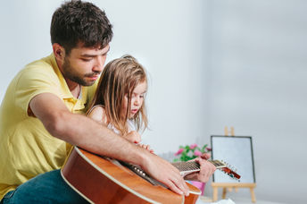 Dad singing to daughter.