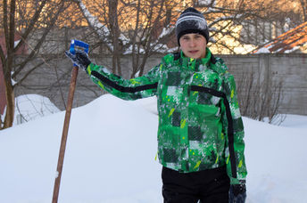 Teen shoveling snow.