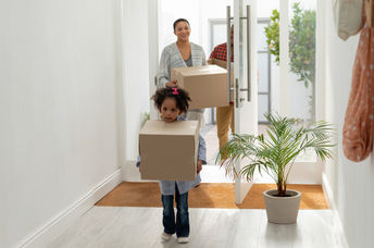 Front view of happy family entering their new home.