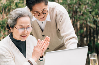 Senior couple using a laptop to code