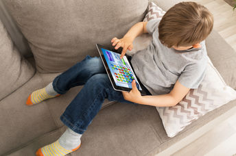 kid using an app on a tablet.