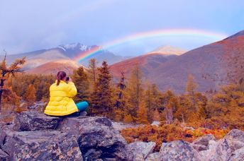 Finding courage while seated in nature admiring a rainbow.
