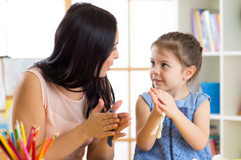Mother and her daughter deep in conversation while doing art.