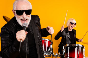 Portrait of cheerful seniors enjoying playing music.