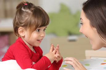 Mother and toddler conversing.