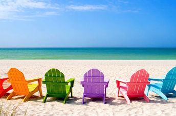 Colored chairs on a scenic shore suggesting positive potential.
