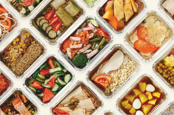 Restaurant food is wrapped in foil tins, ready for doggie bags.