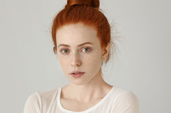 A portrait of a redhead woman.