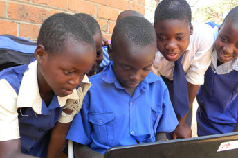 African students learning to use a computer.