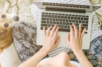 Typing on a laptop keyboard.