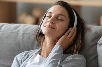 A young woman listening to music.