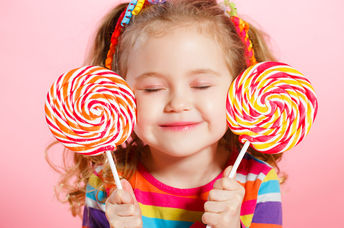 Happy child with candy lollipops.