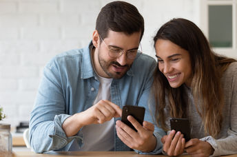 A couple using a smartphone.