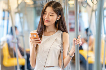 Young passenger listening to music during her commute.