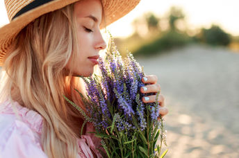 Women smelling fragrant flowers