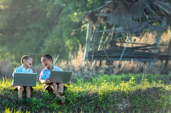 Two boys studying with a laptop.