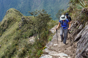 Two hikers walking on Inca trail of Machu Picchu.