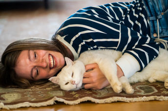 Girl relaxing to the sounds of a purring cat.