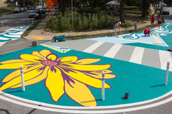 Artists and volunteers paint a colorful intersection in Pittsburgh, PA.